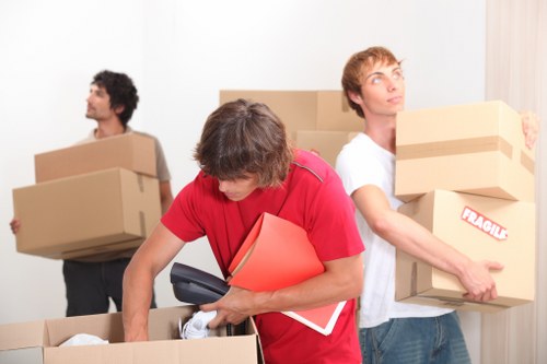 Local piano movers navigating narrow access in a central London property